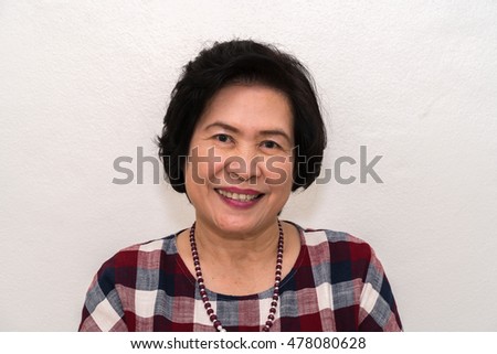 Close-up portrait of old woman smiling
