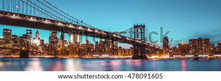 Manhattan Skyline and Manhattan Bridge At Night. Manhattan Bridge is a suspension bridge that crosses the East River in New York City