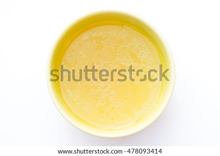 Bowl of chicken broth isolated on white background