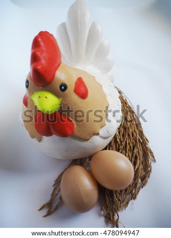 Hen and its eggs on paddy rice
