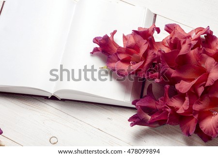 Open book on light table. The flower on a background of book. Back to school. Copy space