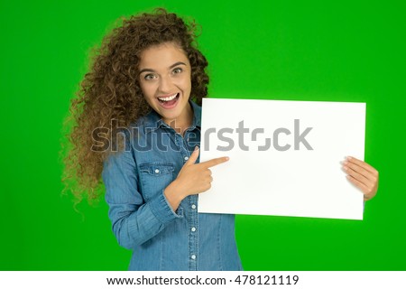 The beautiful woman show empty sheet of paper the green background
