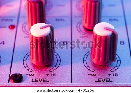 mixing console two lines level closeup with disco colors