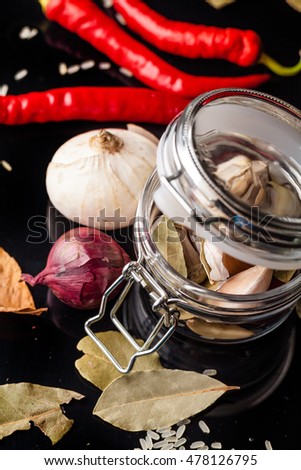 for preserving vegetables in a glass jar on a black table, vegetarianism