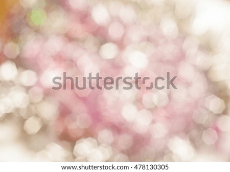 Blurred background with bokeh lights in shades of pale reddish