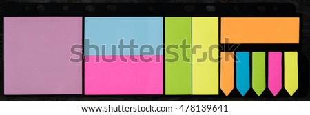 Stickers on a dark background. Bright colored stickers on dark board.