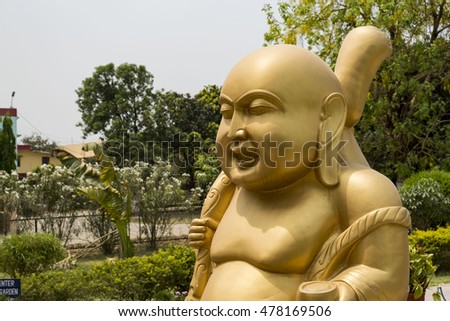 Statue of Laughing Buddha in Sarnath, India where Lord Buddha gave his first sermon.