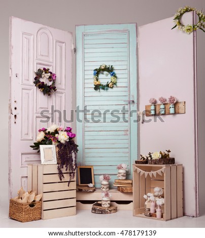 Interior decoration setup with flowers and picture frame.Pink doors,flowers,apple boxes.Great for wedding interior