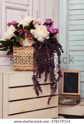 Picture frame and flowers on wooden box.Pink doors,flowers,apple boxes.Great for wedding interior