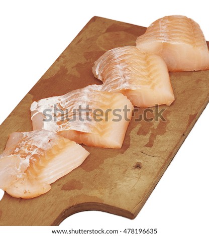 Cod fillet in pieces on the cutting board on white background
