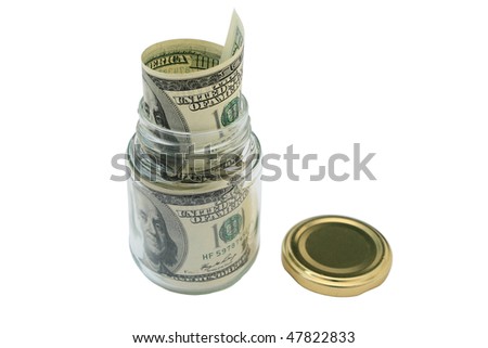 Money in a glass jar. Close-up. Isolated on a white background.