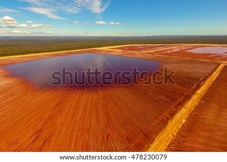 Aerial View of Red Tailing Ponds under a Blue Sky on a Sunny Day