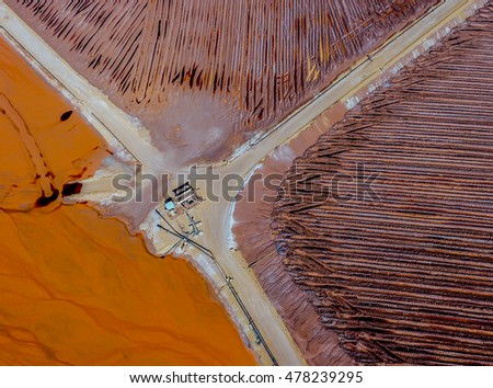 Abstract Aerial View of Red Tailing Ponds With Roads and Canals on a Sunny Summer Day in 