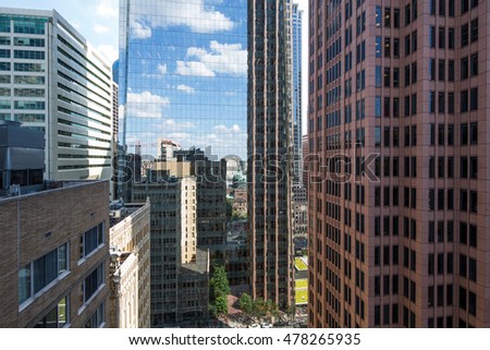 Street view with skyscrapers reflected in glass in the City Center of Philadelphia, Pennsylvania, USA.