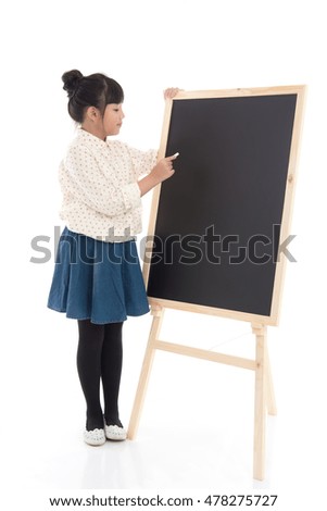Beautiful Asian girl writing on black board on white background isolated