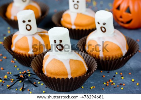 Halloween scary ghost cupcakes background selective focus
