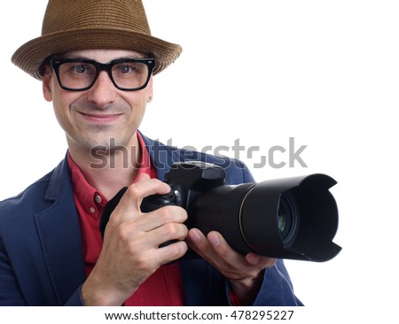 portrait of handsome photographer holding a camera. Isolated