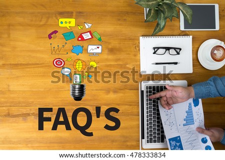 FAQ'S Businessman working at office desk and using computer and objects, coffee, top view, with copy space