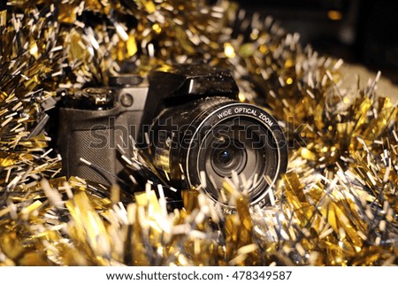 Christmas and new year's tinsel and a camera