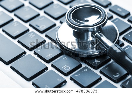 Stethoscope on laptop keyboard, closeup 
