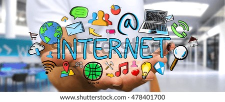 Businessman holding hand-drawn internet presentation in his hand on blurred background