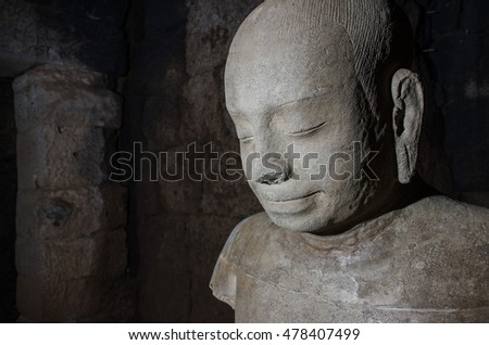 close up faces old Stone statues Cambodia in dark background with space for message adapted of Ancient art Template