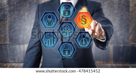 Male corporate governance officer is activating a legal section sign on a virtual control screen. Business concept for Governance, Risk Management, and Compliance, short GRC, and enterprise modeling. Royalty-Free Stock Photo #478415452