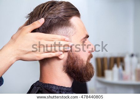 Bearded man sitting in the barbershop Royalty-Free Stock Photo #478440805