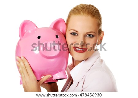 Young business woman holding piggybank