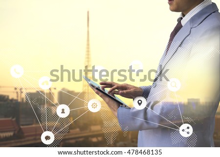 Business concept. Businessman working use tablet. Touching screen Worldwide connection technology interface. Horizontal mockup. with blur antenna in city sunset background