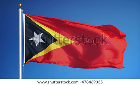 East Timor waving against clean blue sky, close up, isolated with clipping path mask alpha channel transparency