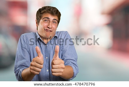 Close up of a funny young man with okay gesture