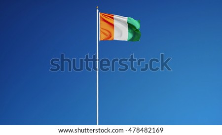 Cote Ivoire flag waving against clean blue sky, long shot, isolated with clipping path mask alpha channel transparency