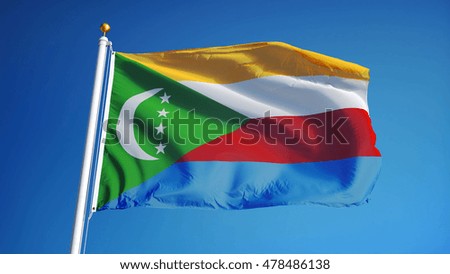 Comoros flag waving against clean blue sky, close up, isolated with clipping path mask alpha channel transparency