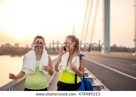 Two friends training outdoors on the bridge.