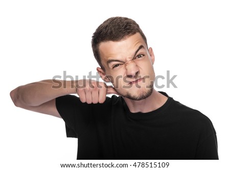 Young man gesturing a cutting motion on her throat over white background.