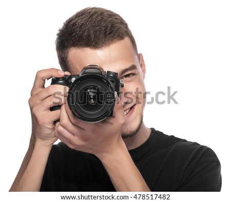 Handsome young man holding a DSLR camera. On white.
