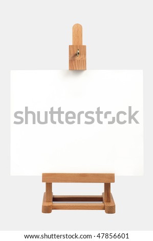Studio easel with blank canvas isolated on black background