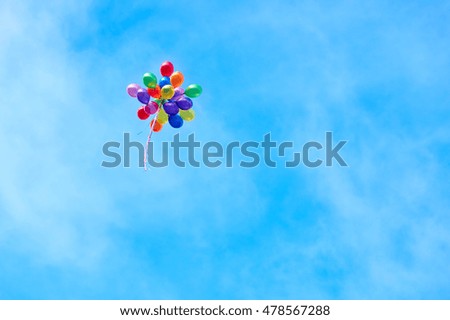 A Bunch Of Colored Balloons Flying Off Into A Blue Sky