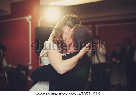 Marvelous picture of newlyweds kissing during their first dance