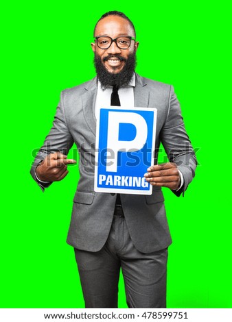 business black man holding a parking banner