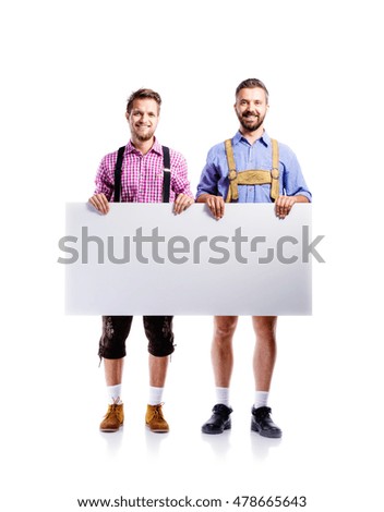 Two hipster men in traditional bavarian clothes, studio shot