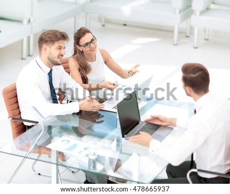 Image of business partners discussing documents and ideas at mee