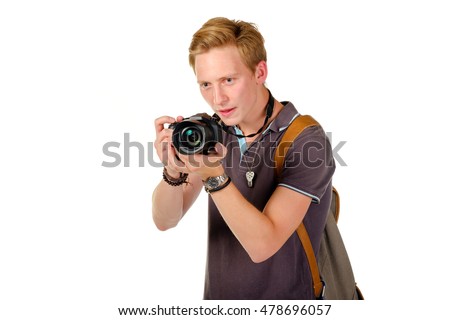 Young man traveler taking pictures by dslr camera isolated on white