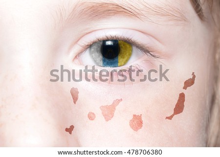 human's face with national flag and map of canary islands. concept