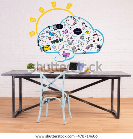 Contemporary workplace with creative communication icons drawings on white brick wall. Social media concept