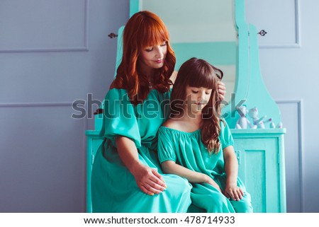 Happy redhead mother with her lovely daughter