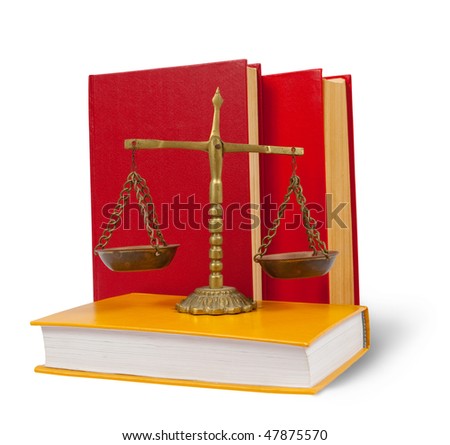 Brass scales of justice atop legal books over white