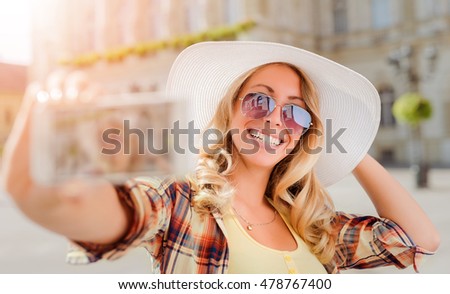 Young woman making selfie in the city.