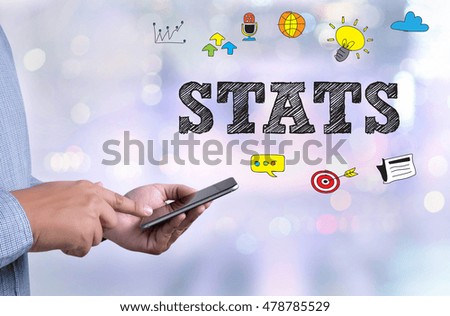 STATS person holding a smartphone on blurred cityscape background